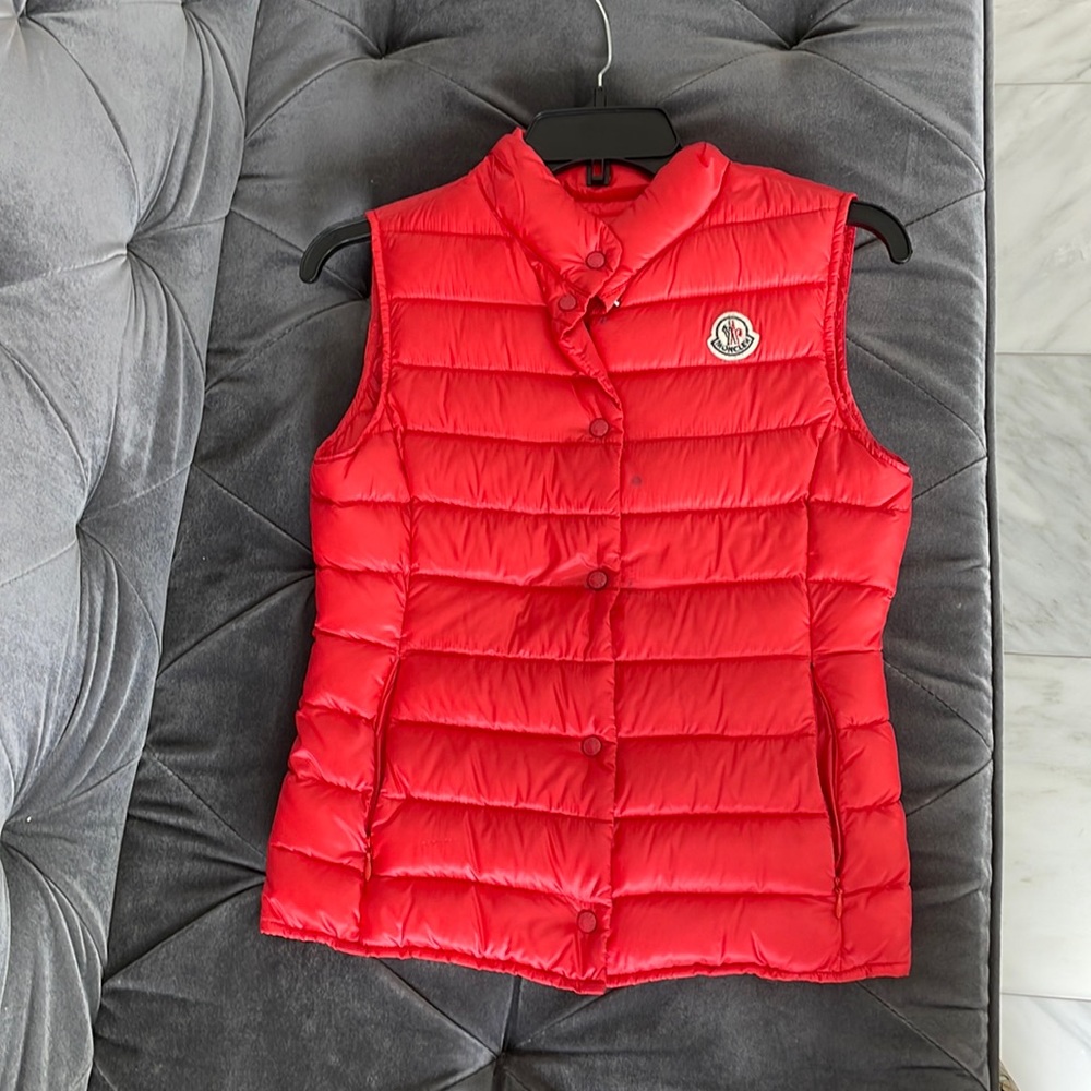 Moncler orange vest.